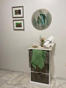 a table with a green towel on it next to a wall at AljaLux Sevilla Bormujos in Bormujos