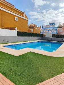 a swimming pool in the backyard of a house at Casa Trastévere in San Juan de los Terreros