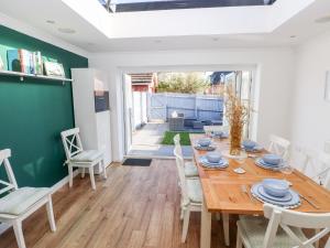 a dining room with a wooden table and chairs at 12 Clos Yr Wylan in Barry