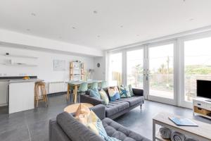 a living room with a couch and a table at The Beach House in Wadebridge