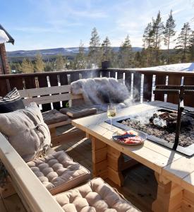 a patio with a table and a fire pit at Varglyan - Idre in Idre