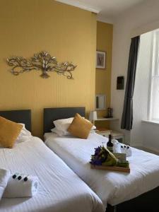 托基的住宿－Babbacombe Palms，酒店客房,配有两张带鲜花的床