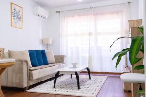 a living room with a couch and a table at Ana Lux Master apartament in Podgorica
