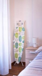 a bedroom with a surfboard on the wall next to a bed at Ana Lux Master apartament in Podgorica