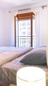 a bedroom with a bed and a large window at Ana Lux Master apartament in Podgorica