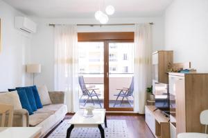 a living room with a couch and a table at Ana Lux Master apartament in Podgorica