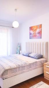 a bedroom with a large bed with a large window at Ana Lux Master apartament in Podgorica