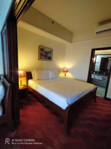 a large bed in a room with a window at THE ROSEMARY SUITE At TIMES SQUARE in Kuala Lumpur
