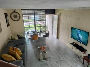 a living room with a couch and a tv at Neatly Furnished Apartment in Mataffin