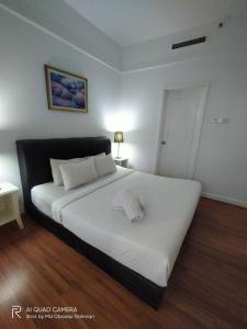 a bedroom with a large white bed with white pillows at THE ROSEMARY SUITE At TIMES SQUARE in Kuala Lumpur
