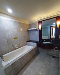a bathroom with a bath tub and a sink at THE ROSEMARY SUITE At TIMES SQUARE in Kuala Lumpur