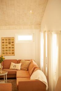 a living room with a couch and a window at Blomstertantens Hus in Trelleborg