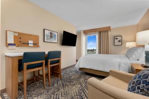 a hotel room with a bed and a desk at Candlewood Suites Collingwood, an IHG Hotel in Collingwood