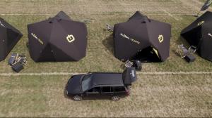 a car parked in the grass with umbrellas at TT Camping Jan & Bertha - by Global-Tickets in Assen