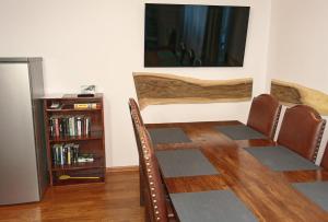 a living room with chairs and a book shelf at Panskiemisie Domki Całoroczne sauna jacuzzi in Wetlina