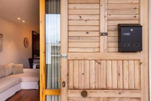 a wooden door in a living room with a couch at La Dimora del Benessere in Noicattaro +24 photos
