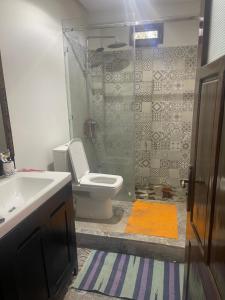 a bathroom with a toilet and a sink and a shower at Riad Targante Takate 2 in Takkat