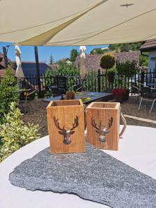 two chairs with antlers on them on a table under a tent at Auberge Passepartout in Zeihen