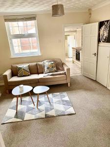 a living room with a couch and two tables at Bedford town house in Bedford