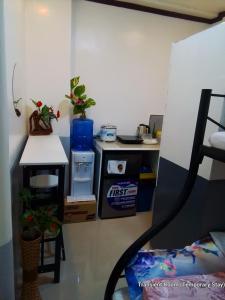 a room with a desk and a table with a table at Parayno's Residence in Marikina 1 in Manila +2 photos
