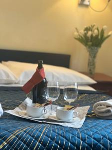 a table with a bottle of wine and two wine glasses at Hotel Vistula in Krak&oacute;w