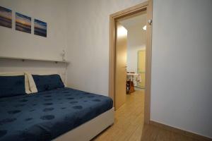 a bedroom with a blue bed and a mirror at Il Girasole in Trebiano