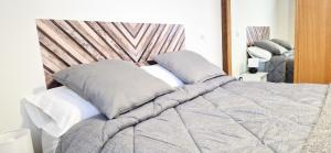 a bed with two pillows on top of it at Apartamento I&F Colombres by Casas de Los Picos in Colombres