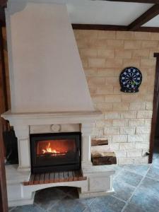 a fireplace in a living room with a fire place at Maison vosgienne 2 à 8 personnes in Rochesson