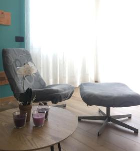 a living room with two chairs and a table at Da Tosca in Gravellona Toce