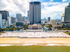 a building on the beach in front of a city at SeaBreeze Panorama Grand Residences in Nha Trang