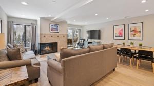 a living room with a couch and a fireplace at Alpinewood Chalet in Vail