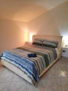 ein Schlafzimmer mit einem Bett mit einer blauen Tasche darauf in der Unterkunft I Gerani Country House in Sorso