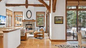 a living room with a couch and a fireplace at Clover Chalet in Edwards