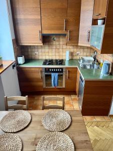 una cucina con tavolo, sedie e lavandino di Wilson Apartment a Varsavia
