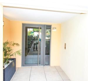 an entrance to a house with a glass door at Jardin Secret YourHostHelper in Antibes