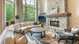 a living room with a couch and a fireplace at Bergrose Lodge in Vail