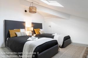 Dos camas en una habitación con apartamentos de 2 dormitorios en Akicity Seia Chill, en Seia