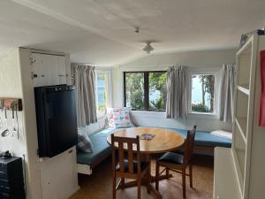 a living room with a table and a couch at Resolution Bay in Resolution Bay