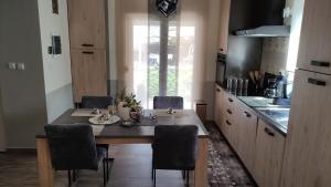 a kitchen with a table and chairs in a kitchen at Holiday home Anima Mea, Zadar in Zadar