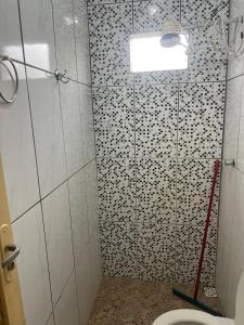a bathroom with a shower with a toilet and a mop at Rancho São Francisco in São Roque de Minas