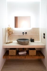 a bathroom with a sink and a mirror at Dwell House 5 in Ioannina