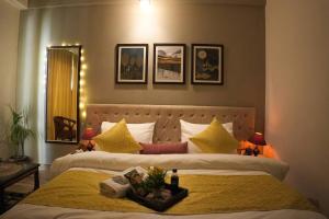 a bedroom with two beds with yellow pillows at Luxury Apartment Near Pari Chowk in Greater Noida