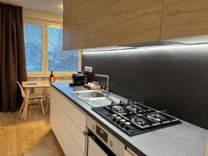 a kitchen with a sink and a stove top oven at Apartmán Centrum Komfort in Zvolen