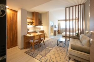 a kitchen and living room with a couch and a table at Dwell House 5 in Ioannina