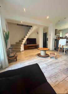 a living room with a staircase and a table at Belle maison proche du centre et des plages in Montpellier