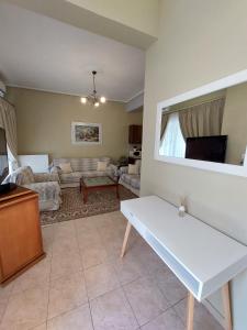 a living room with a white table and a couch at Despo's Apartment in Volos