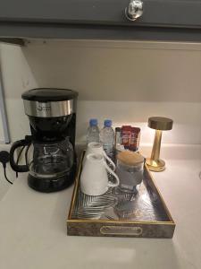 a tray with a coffee maker and a mixer on a counter at شقة فاخرة للايجار اليومي in Al Kharj