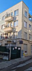 a tall building with a fence in front of it at GRAND APARTMENT OHRID - top center near to sea and sea garden in Burgas City