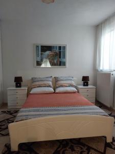 a bedroom with a bed with a picture on the wall at Despo's Apartment in Volos