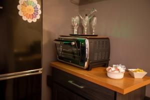 a microwave sitting on top of a wooden table at Luxurious Pool Cottage Sleep 2 in Carlton